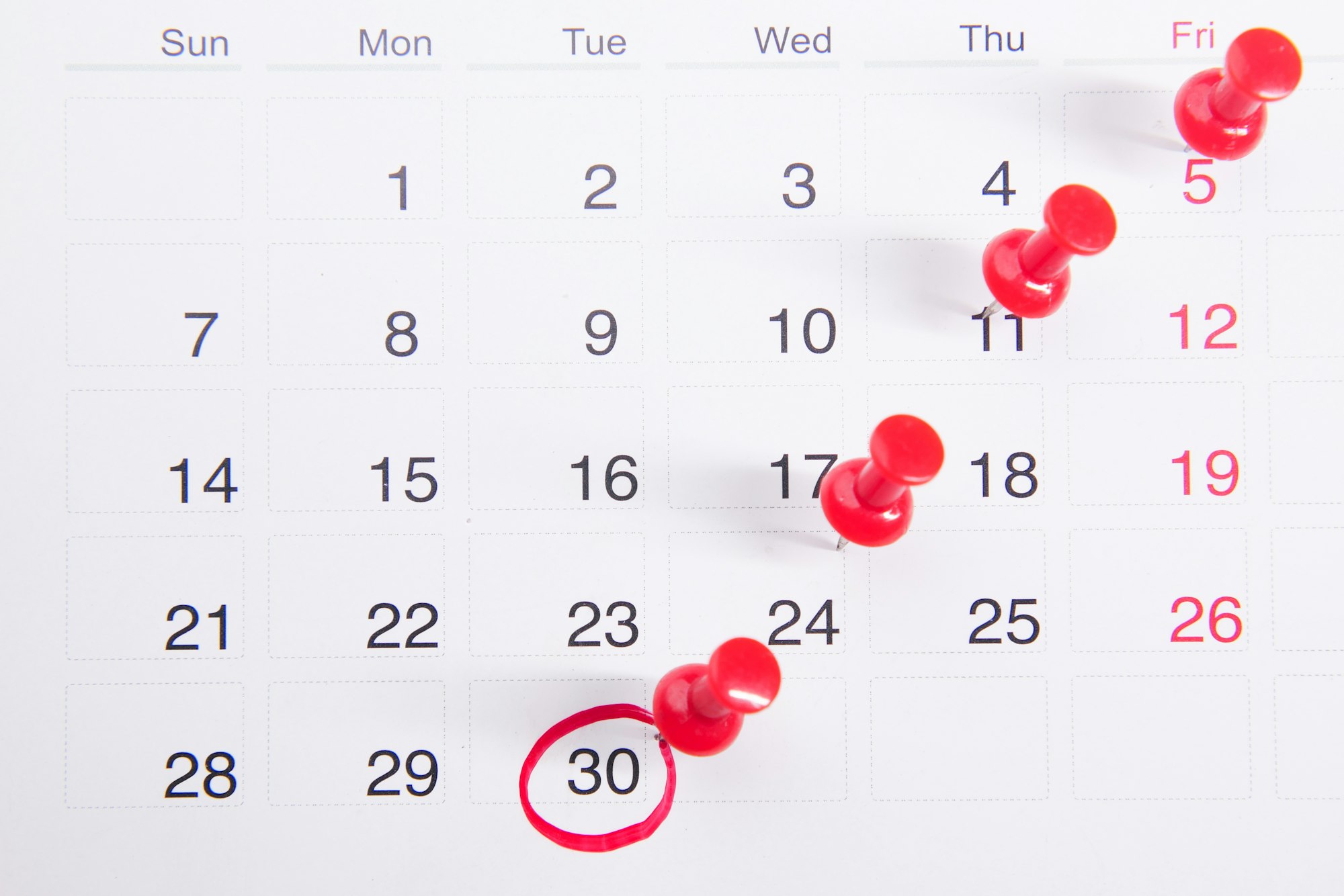 Calendar with push pins representing press release timing