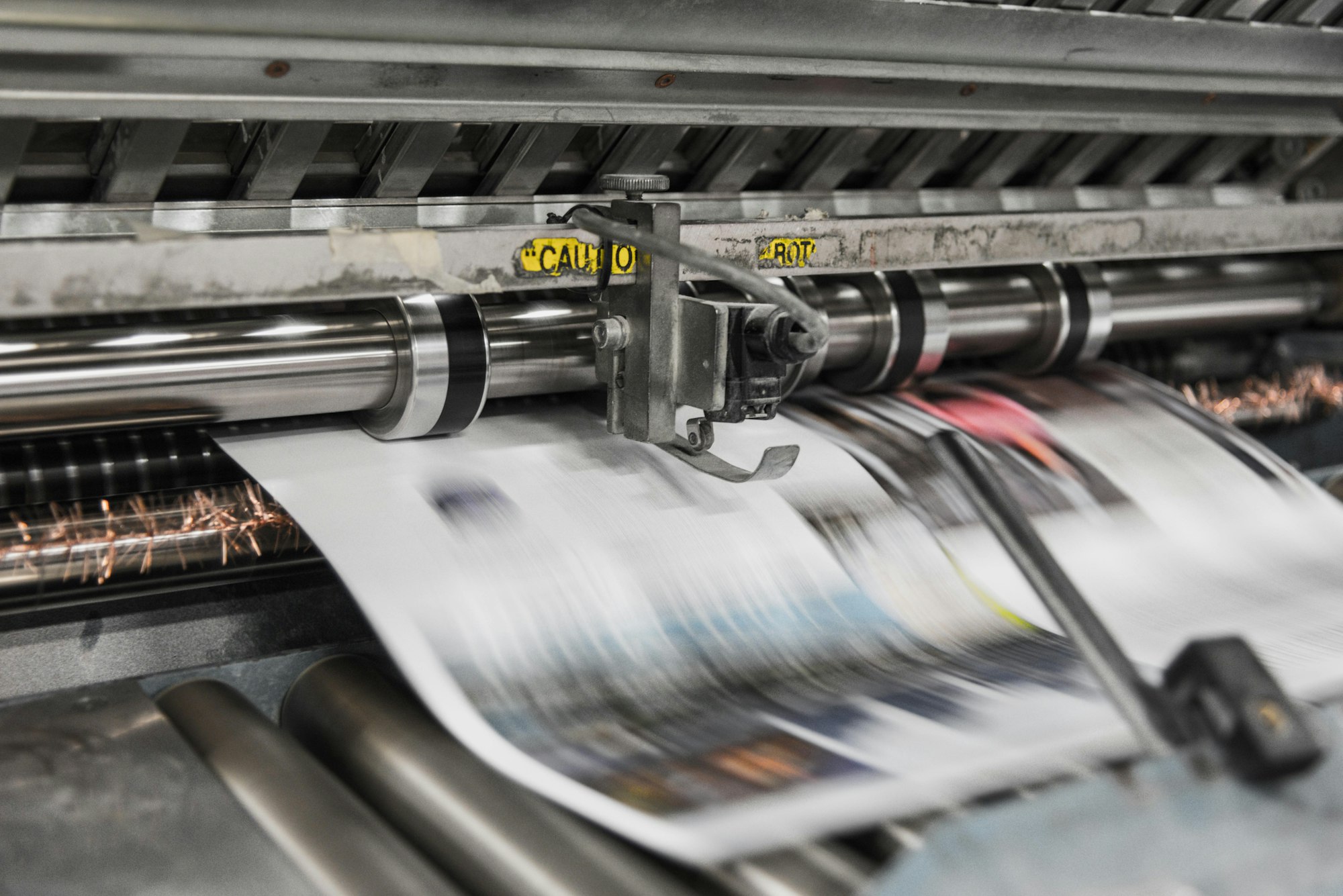 Industrial newspaper printing press representing press release syndication