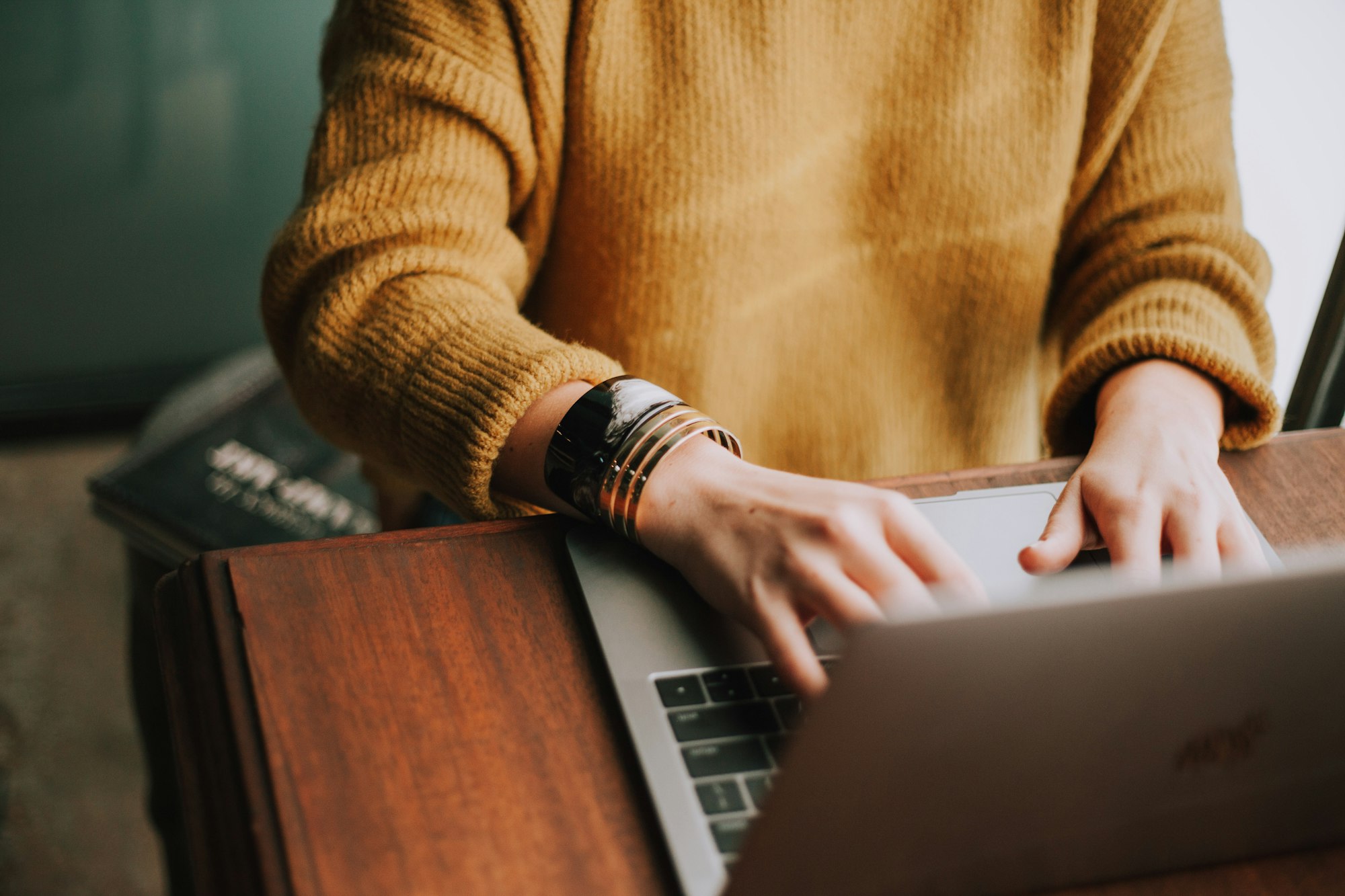Person typing on a laptop, taking action on their SEO strategy