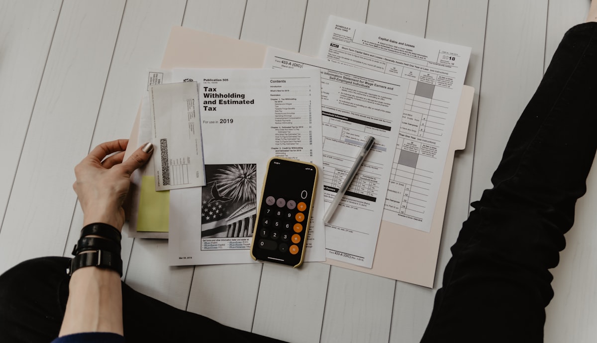 Calculator and financial documents on a desk - representing the Hayward CPA practice that climbed from rank 20+ to #1 across their market in 136 days