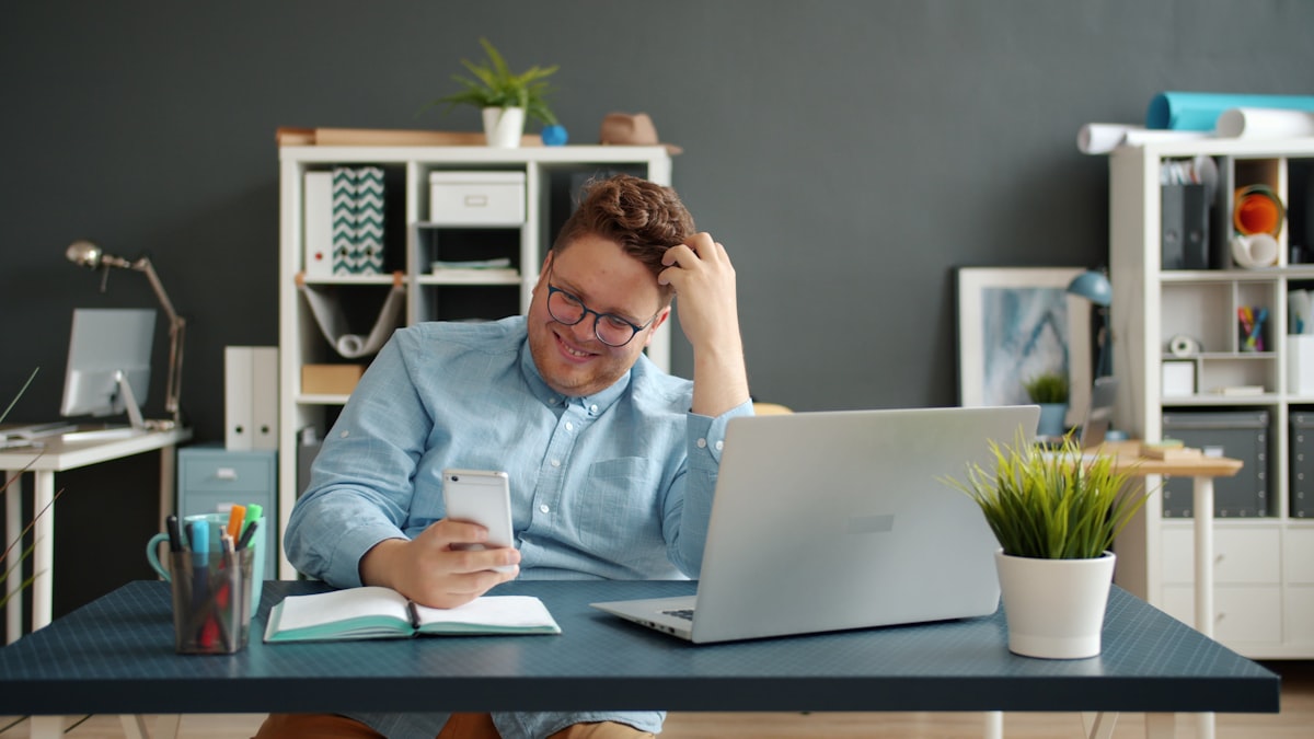 Business owner smiling while looking at phone - representing the Richmond District professional services practice consistently discovered by locals