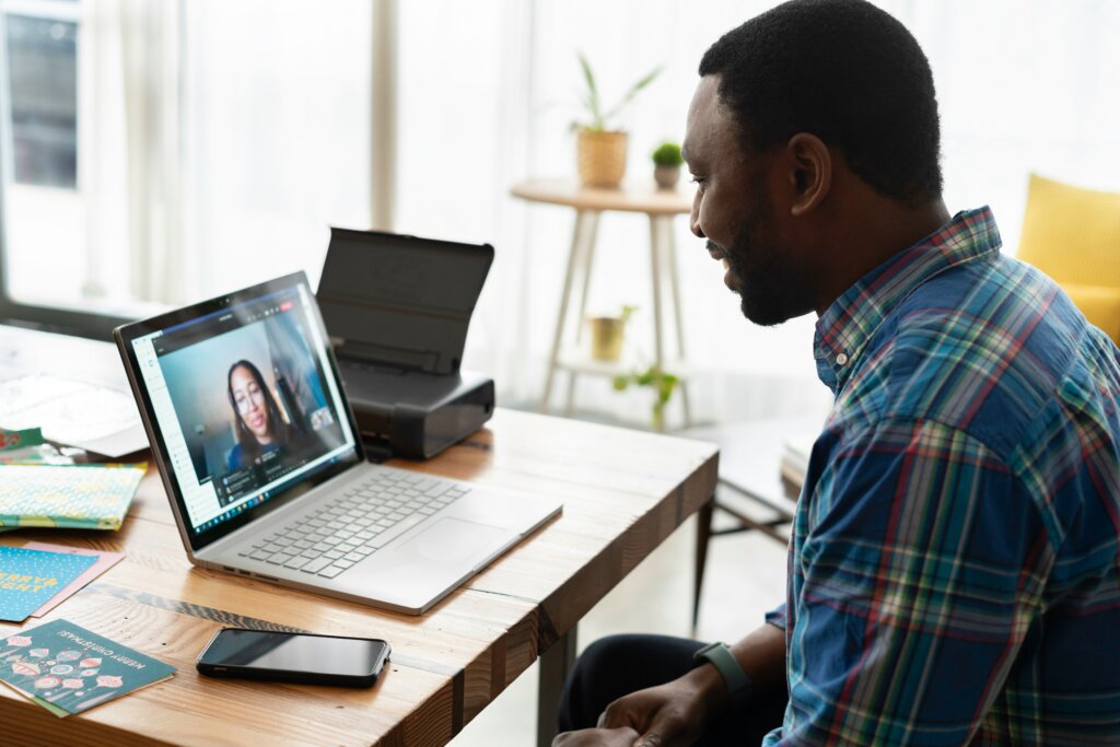 Cosmetic surgeon marketing—practice manager on Zoom call planning digital marketing strategy for cosmetic surgery clinic.