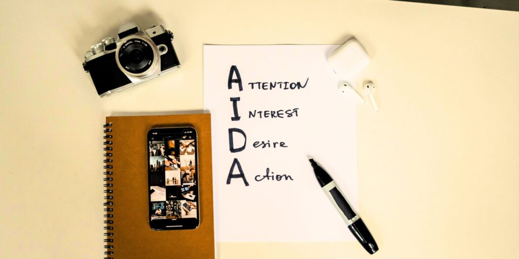 Content Marketing - San Francisco SEO Services | J Williams Designs - AIDA Marketing AIDA model hierarchy handwritten on paper by marketing professional